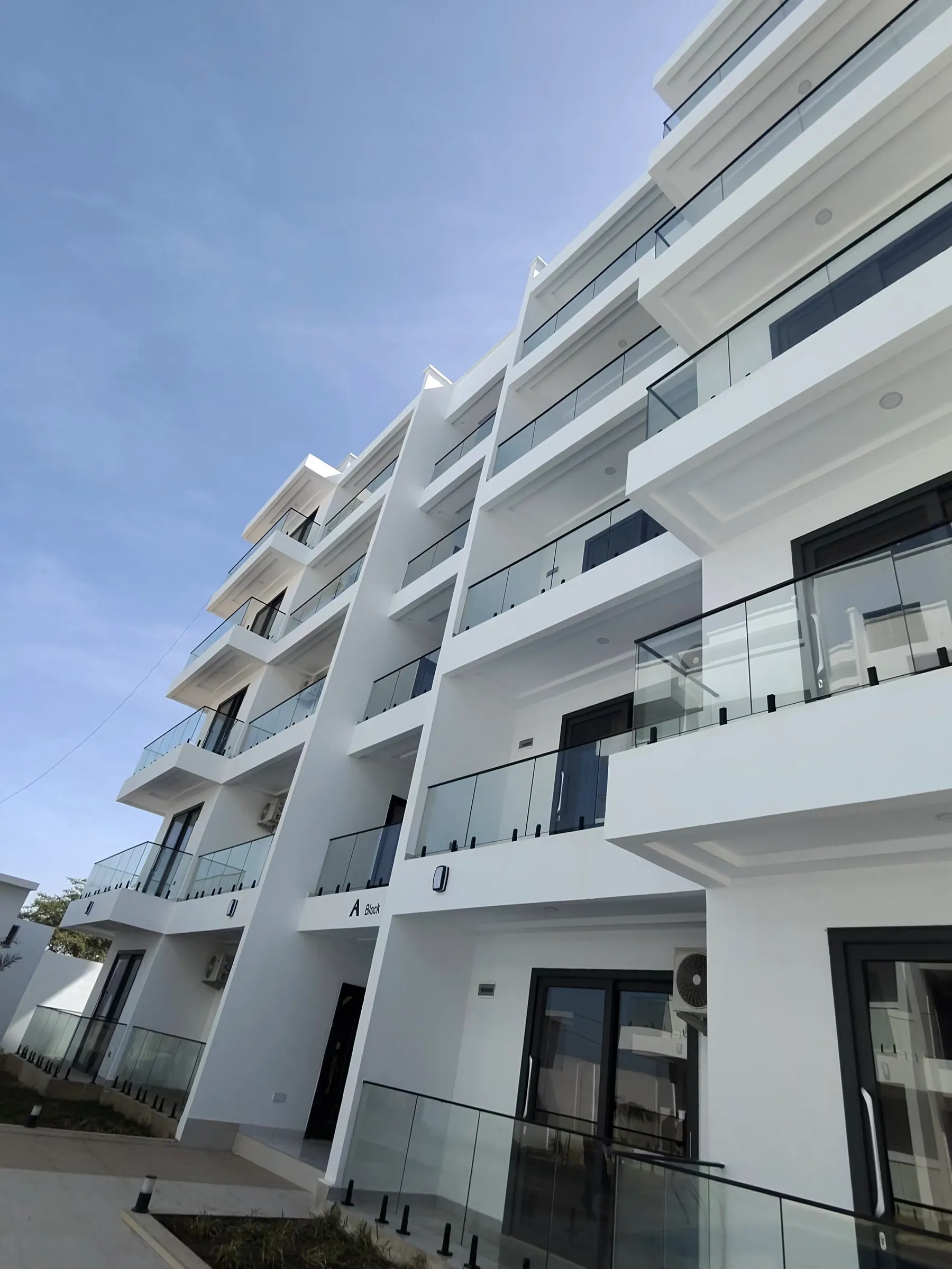 Glass balconies on a white façade